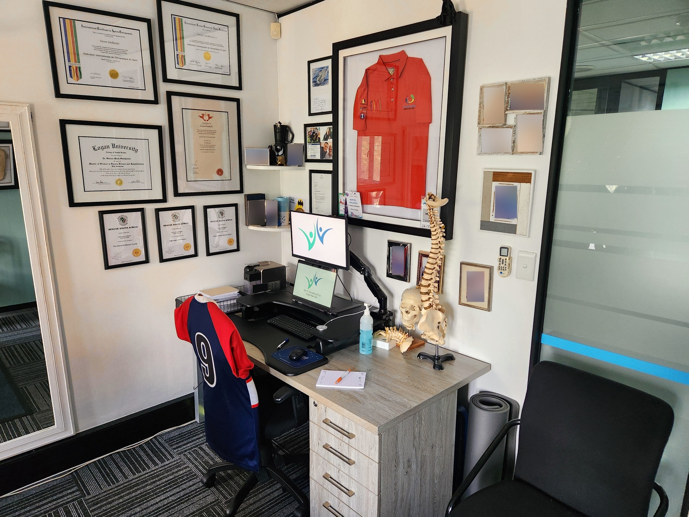Steven's desk, with his certificates on the wall above it