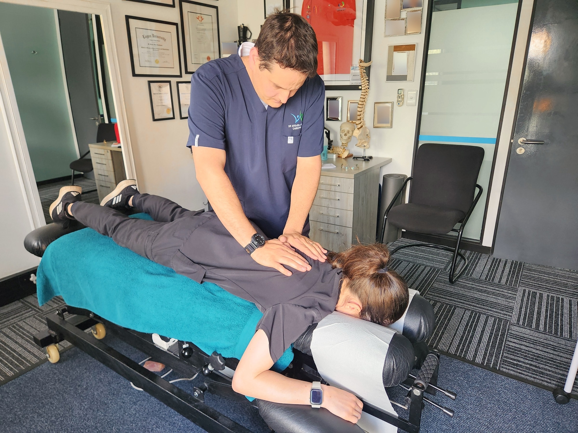 Steven treating a patient's upper back on the treatment table